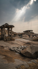 little stone temple with dramatic mystic sky in hampi india karnakata