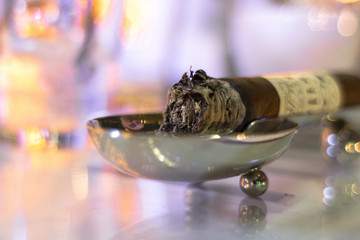 Cigar cigarette butt. Stand for cigars. Smoldering cigar. Twisted tobacco. Ashtray with a cigar....