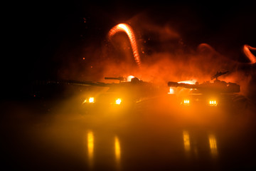 War Concept. Military silhouettes fighting scene on war fog sky background, World War German Tanks Silhouettes Below Cloudy Skyline At night. Attack scene. Armored vehicles. Tanks battle