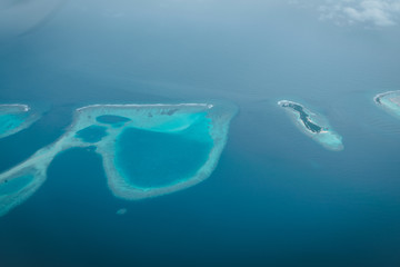 Maldives from the Sky with the blue sea and white sand and beach in the indian ocean