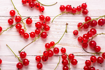 Fresh red currant on a white wooden background Top view