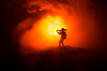 Obraz na płótnie Canvas Military soldier silhouette with bazooka. War Concept. Military silhouettes fighting scene on war fog sky background, Soldier Silhouette aiming to the target at night