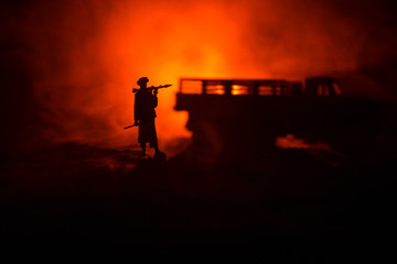 Military soldier silhouette with bazooka. War Concept. Military silhouettes fighting scene on war fog sky background, Soldier Silhouette aiming to the target at night