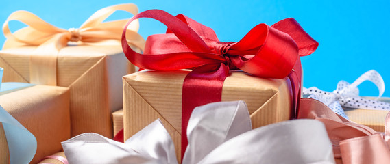 Gift boxes with red bow on a blue background, banner