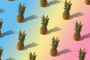 Fototapeta premium Neon pineapple fruits pattern on pink and blue background. Summer concept