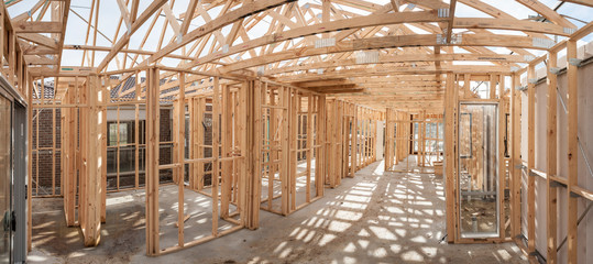 Panoramic interior view of a  wooden timber frame from a new house under construction