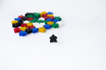 Groups of colorful meeples isolated on white background. Small figures of man. Board games concept. . Business strategy. Leader of thoughts of company. Components of card games.