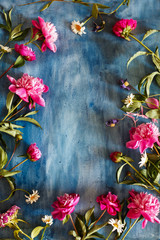 Beautiful peony flowers on dark textured background