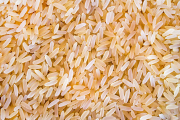 Polished rice scattered in a thin layer. Backgrounds, textures.