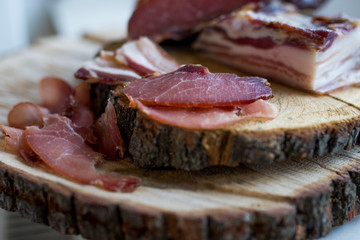  prosciuto slices  on wooden chopping board