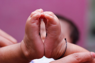 Baby feet in mother hands