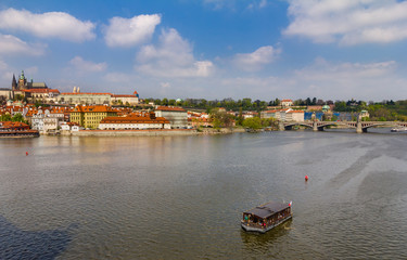 View of historical center of Prague, buildings and landmarks of old town. Boat cruise on Vltava river. Czech Republic. Top tourist attraction in Europe. Concept of travel, sightseeing and tourism. 
