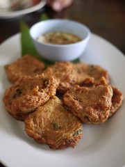 Fried Fish-paste balls with tomato and cucumber in white dish on morning time