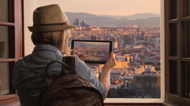 tourist takes photo of vienna skyline at sunset,traveler woman photographs city from above using tablet