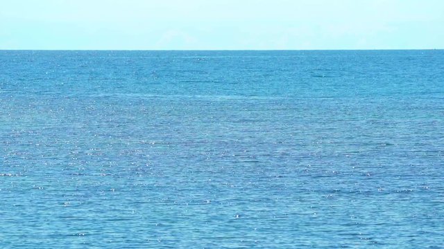 horizontal line devide the smooth wave in sea and the clear sky, shooting from Munnok Island, Thailand