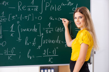 Young female student in front of the chalkboard
