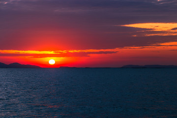 Natural background during the sunrise, horizon by the sea, Twilight light wallpaper of bright orange sky. 