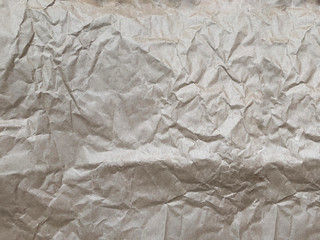 Brown wrinkled paper background. Background with rumpled paper texture.