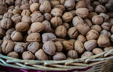 Background of a walnut in a wicker basket close-up