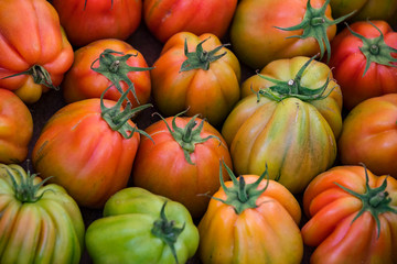 Background of ripe non-GMO tomatoes on the market in Milan in Italy.