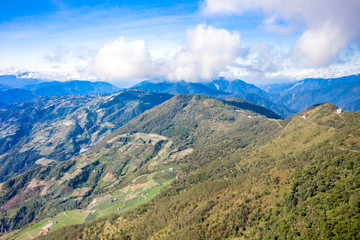 Flying drone towards beautiful amazing famous Mt. Hehuan in Taiwan over above the hilltop, aerial view shot.