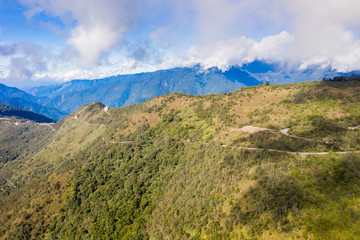 Fototapeta premium Flying drone towards beautiful amazing famous Mt. Hehuan in Taiwan over above the hilltop, aerial view shot.