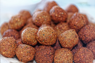 Deep frying falafel. Traditional Mediterranean healthy and vegan food with chickpeas and tahini. Selective focus, shallow depth of field