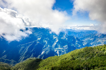 Flying drone towards beautiful amazing famous Mt. Hehuan in Taiwan over above the hilltop, aerial view shot.