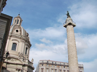 Fototapeta na wymiar Forum of Cesari in Rome with Trajan's Column and church in background