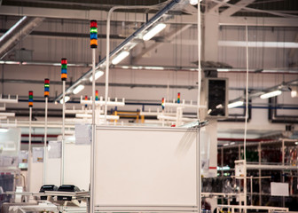 An industrial landscape with workers' blocks at a modern plant in a production workshop with lighting and ventilation and a large stand for the inscription. Logistics
