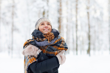 Waist up portrait of happy young woman in winter forest having fun and enjoying snow, copy space - Powered by Adobe