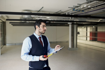 Property surveyor assessing new build commercial office space