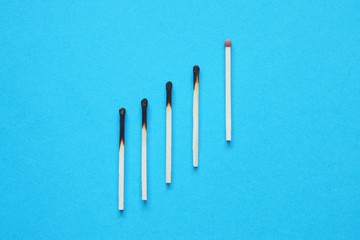 Business concept. Matches on blue background.