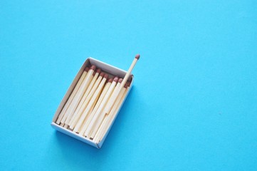 Business concept. Matches on blue background.