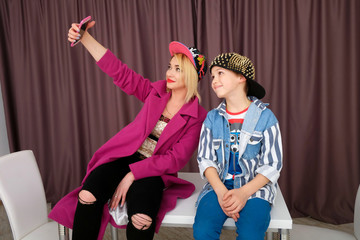 Mother and son tries on clothes and having fun at home