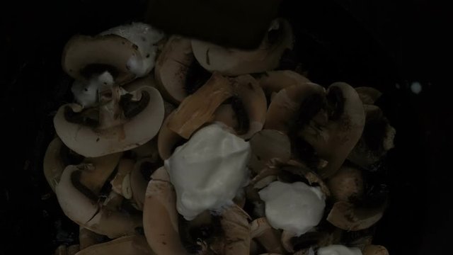 roasting garlic and champignon mushrooms on an old cast-iron pan