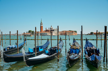 Fototapeta na wymiar Gondolas in Venice. Gondolas on Grand canal. Gondola service tourist people travel around Venice in Italy