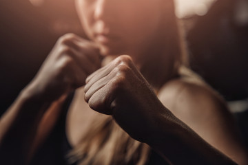 Young female boxer preparing to punch bag. concept of will win, power of spirit - obrazy, fototapety, plakaty