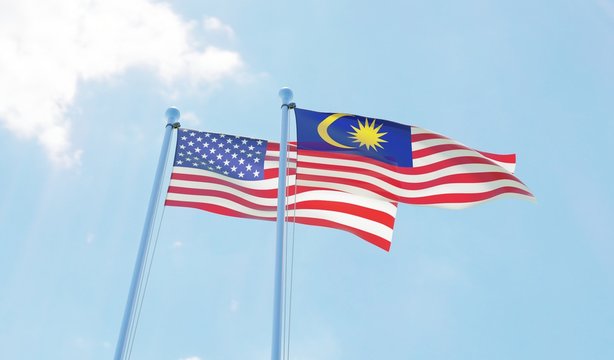 Malaysia and USA, two flags waving against blue sky. 3d image