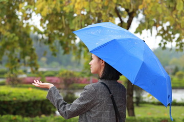 young woman standing in the rain