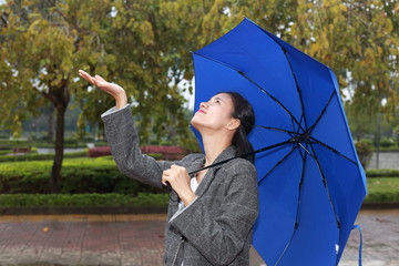 young woman standing in the rain