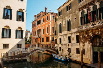 Fototapeta na wymiar Beautiful venetian street in summer day, Italy. Venice, beautiful romantic italian city on sea with great canal and gondolas, Italy.