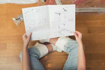 Instruction for furniture assembling in the female hands for self assembly.