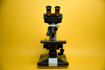 laboratory microscope, yellow background