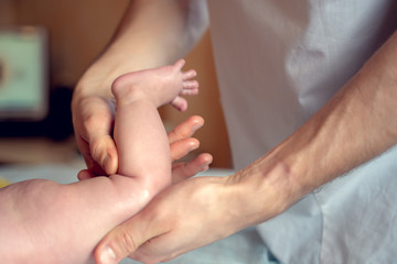 Obraz na płótnie Canvas Image of hands of massage therapist making foot massage to small child