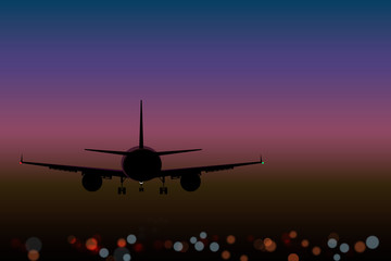 Fototapeta na wymiar airplane on the background lights of the night city bokeh effect top view at sunset