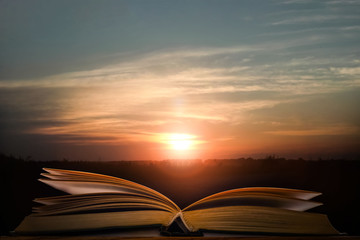 open book lies against the sunset
