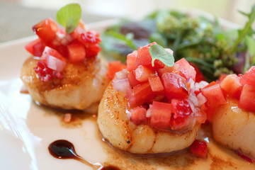 Close Up Caramelized Seared Sea Scallops with Juicy Tomato Salsa