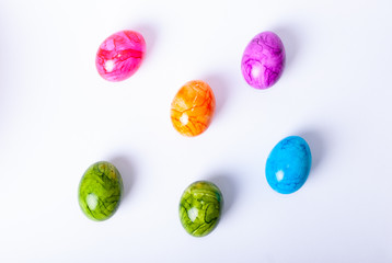 Colorful painted easter eggs laying on white background