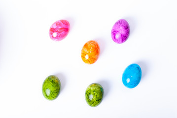 Colorful painted easter eggs laying on white background